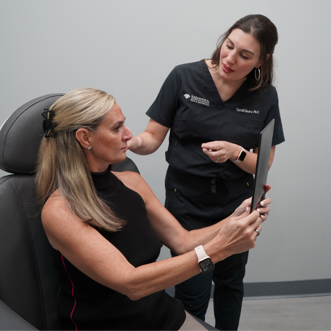 Radiance Rx Pittsboro location Grand Opening event page_picture of PA Cyndi Cleary showing patient results of aesthetics procedure