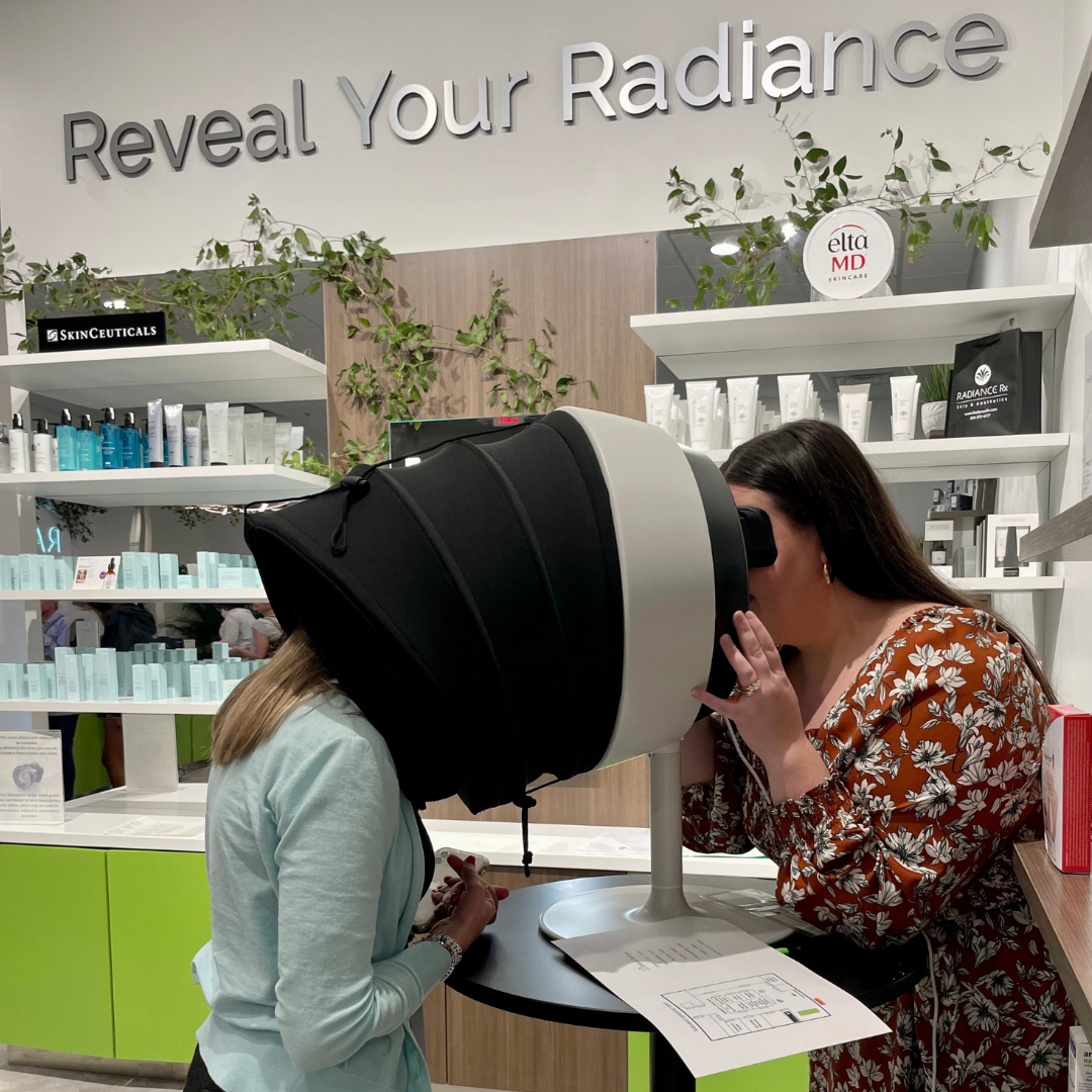 Radiance Rx Pittsboro location Grand Opening event page_picture of event attendees participating in live demonstration of medical aesthetics equipment