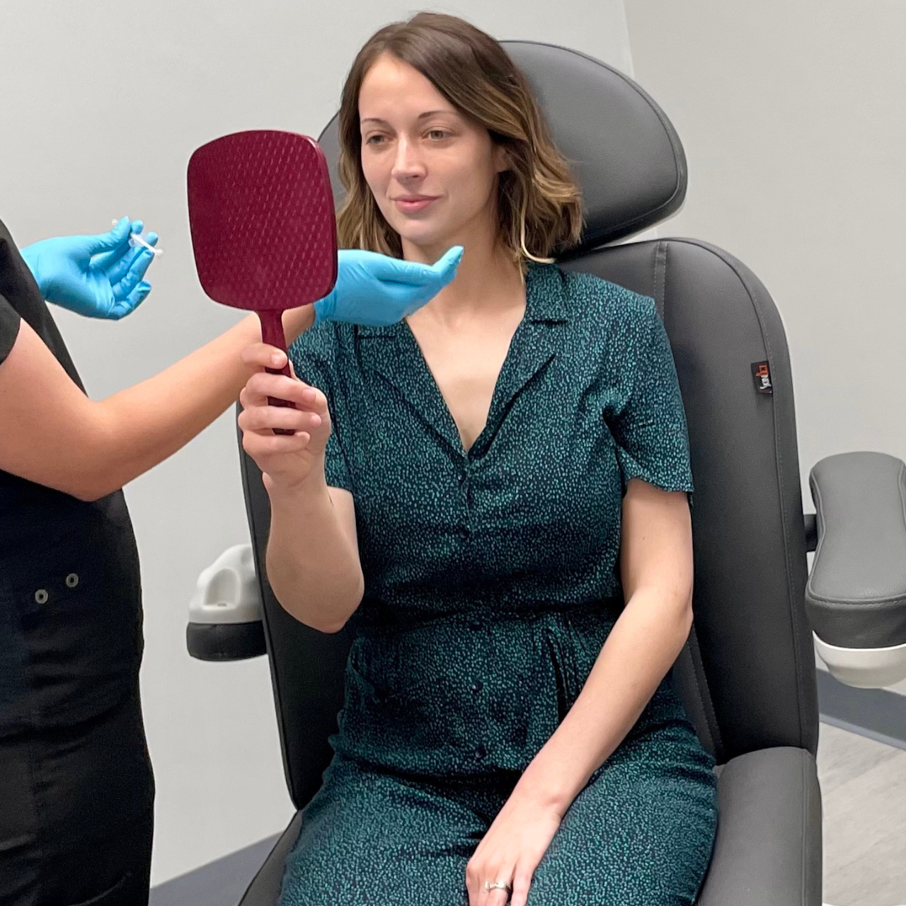Radiance Rx Skin & Aesthetics patient viewing results of live demo at event